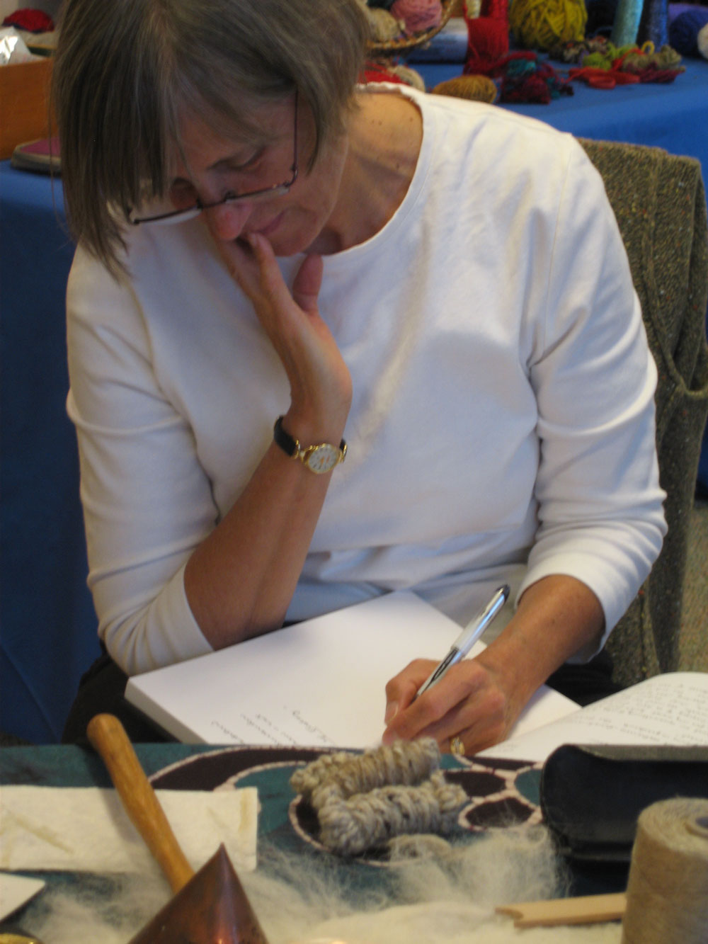 woman thinking and journaling in a book